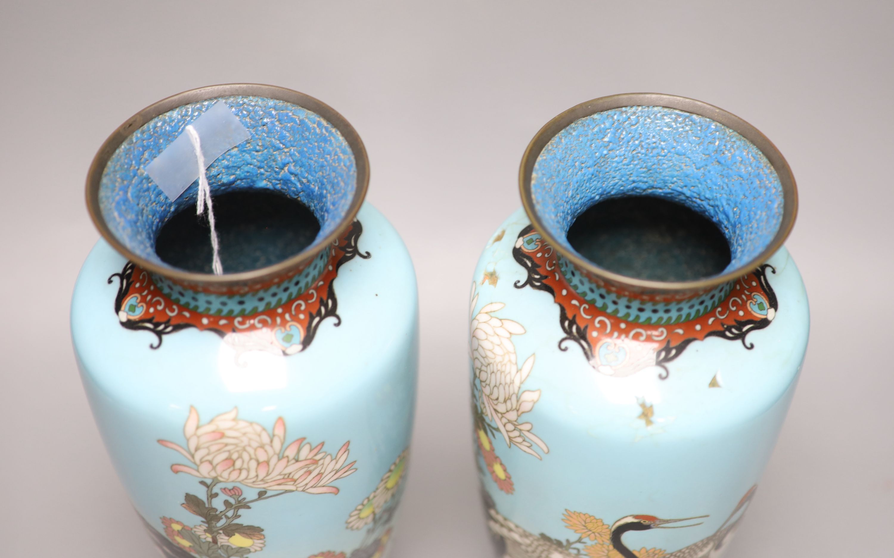 A pair of Japanese turquoise ground cloisonne enamel vases, a large cloisonne bowl and smaller matching bowl, tallest 31cm